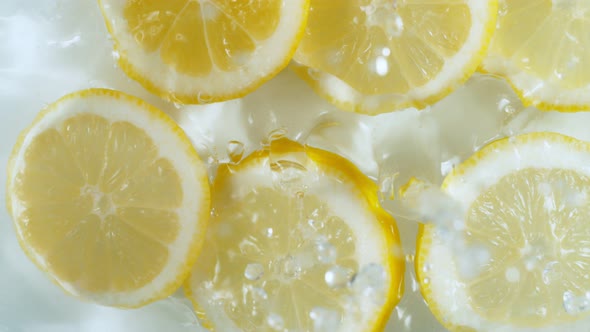 Super Slow Motion Shot of Lemon Slices Falling Into Water at 1000Fps