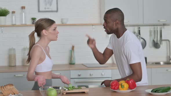 Athletic Woman Arguing with African Man in Kitchen