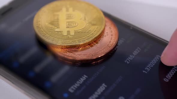 Broker Looks of Cryptocurrency Indicators on Smartphone Screen in a Mobile App