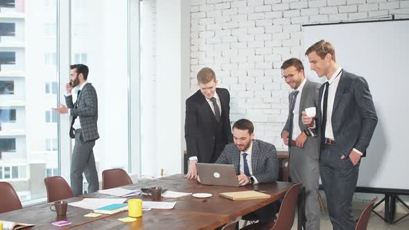 Young Confident Caucasian Men Gathered To Hold Business Meeting Together