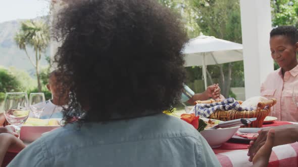 Happy family eating together at table