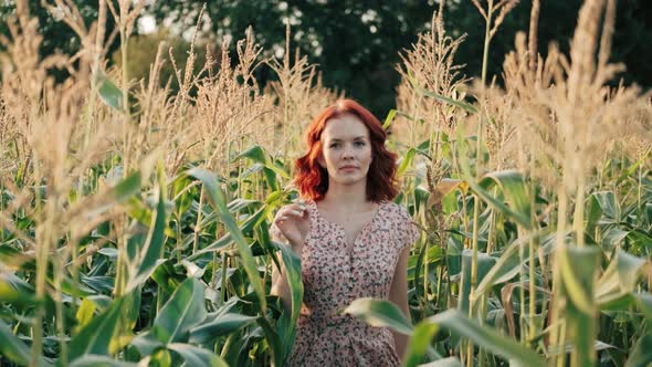 Beautiful Woman Walking on a Sunny Corn Field