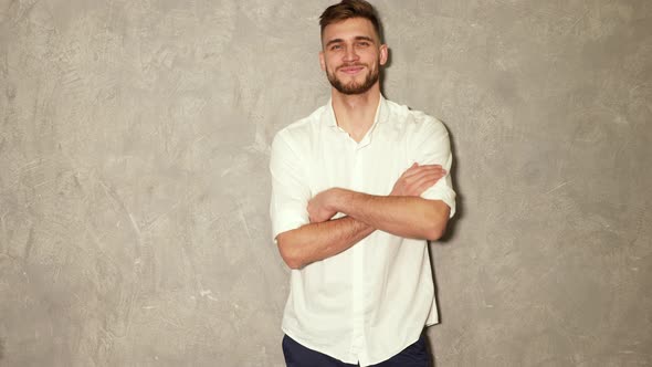 Portrait of attractive bearded stylish young man looking into the camera and smiling