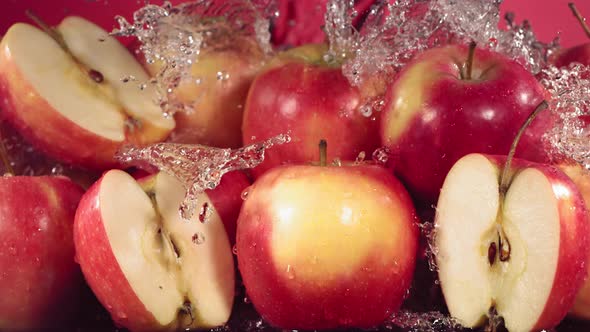 Slow Motion Shot of Red Apple Water Splashing Through Apple Slices