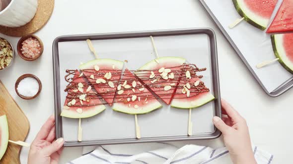 Watermelon drizzled with chocolate and topped with flaked sea salt and almonds.