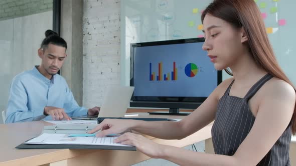 A beautiful Asian businesswoman is smiling in the conference room.