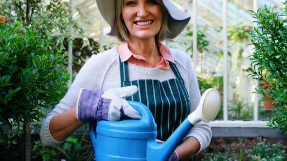 Mature woman holding watering can