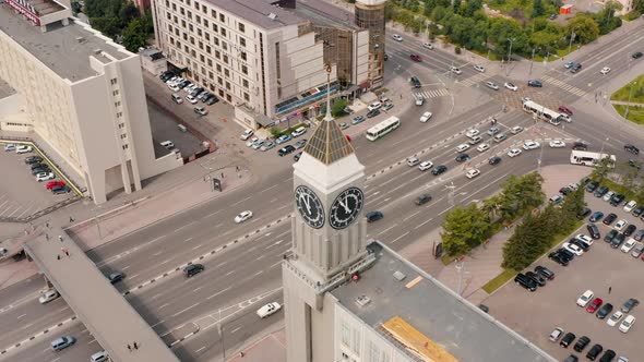 The central street of Krasnoyarsk The clock on the tower Busy traffic Krasnoyarsk