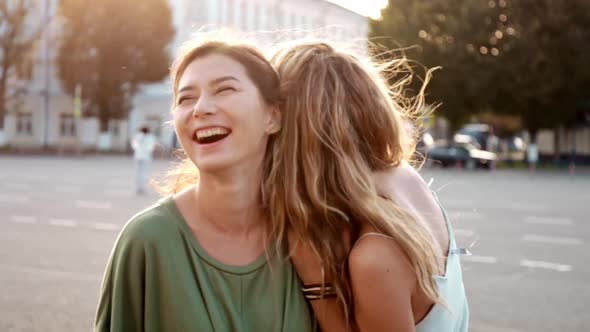 Two Happy Young Girls Hug Each Other