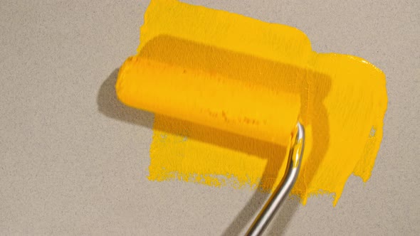 Abstract Brushstrokes of Yellow Paint Brush Roller Applied Isolated on a Gray Background