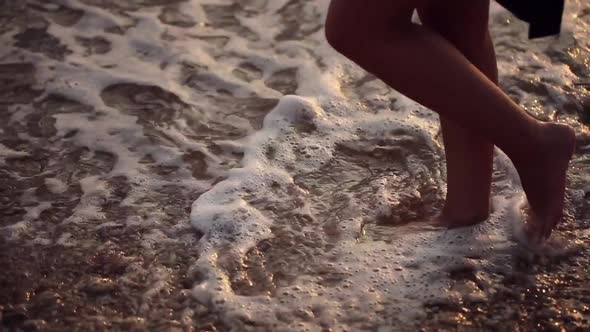 Woman Feet Barefoot in Sea of Foam Waves on Beach Summer Day Approaches