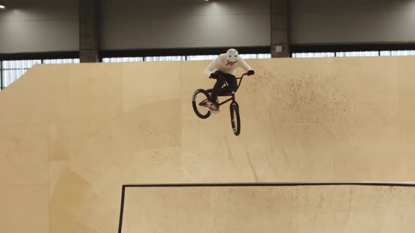 A Man Riding on the Plywood Ramps on His Sports Bike and Performing Tricks in the Air