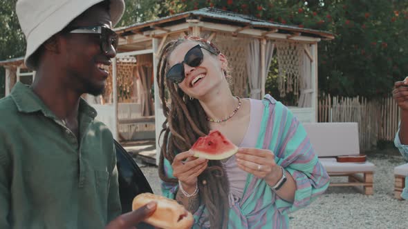 Girl and Guy Having Snacks on Beach