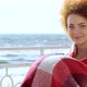 Beautiful Pensive Redhead Woman Sitting at the Beach Watching the Sea - VideoHive Item for Sale
