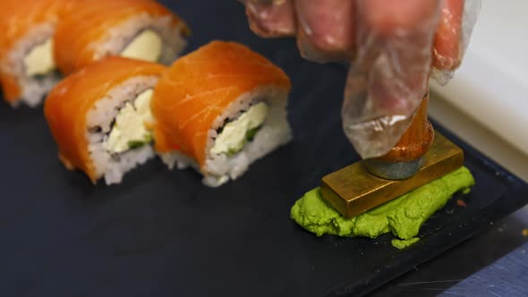 Sushi roll set on black slate background. 