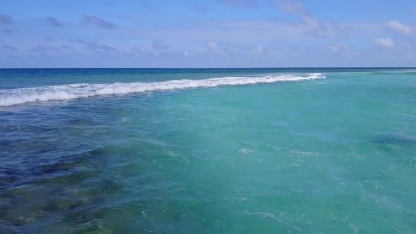 Drone aerial seascape of shore beach by blue water and sand background