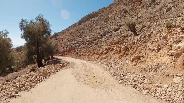 Car ride point of view on the asphalt coastal narrow road on a dramatic landscape