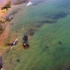 Amazing scenic drone aerial view of the beach and ocean with calm waves during a sunset. - VideoHive Item for Sale