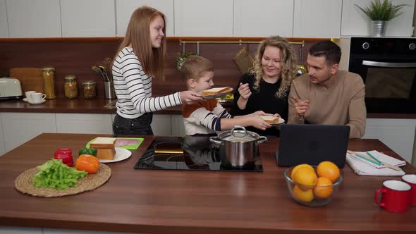 Deaf Parents Rejoicing with Kids in Kitchen