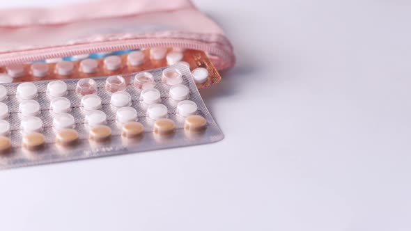 Birth Control Pills on Wooden Background, Close Up 