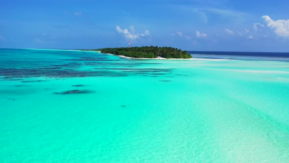 Wide angle drone clean view of a white sand paradise beach and aqua blue water background in colourful