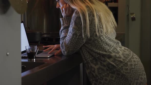 Caucasian woman concentrated and working in her house