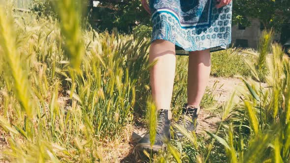 Girl Touches Blooming Spring Meadow From Low Angle Perspective 