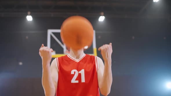 Portrait of an Caucasian Man Basketball Player Serious Looking at the Camera and Throws the Ball in