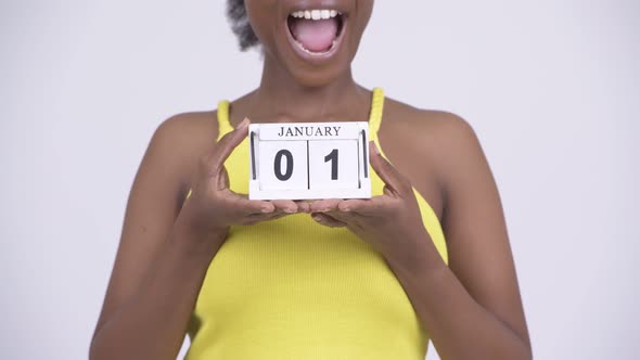 Young Happy African Woman Holding Calendar Block Ready for New Years