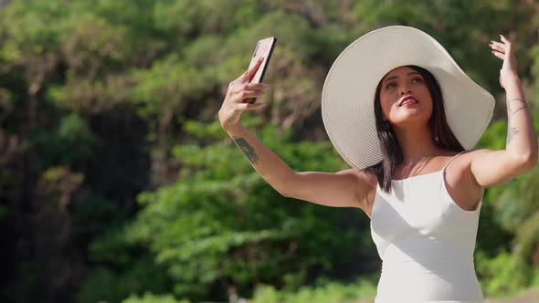 Woman Smiling In Sun Hat To Pose For Selfie On Smartphone