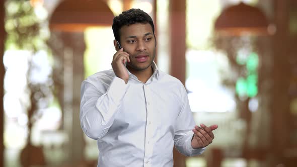 Portrait of Hindu Businessman Talking on Phone