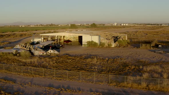 Truck Drifting in Abandoned Aircraft Hangar in Desert Aerial