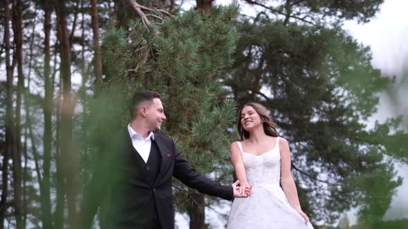 Beautiful Couple of Brides Walking in a City Park Wedding Day