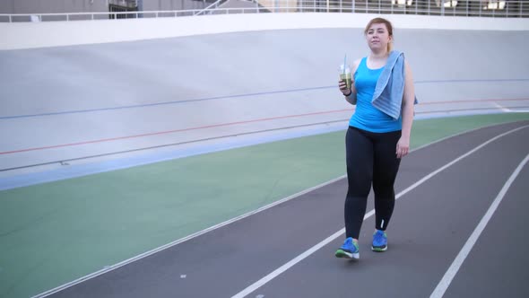 Plus Size Woman Drinking Smoothie After Workout