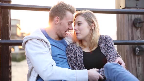 Couple in love embracing and kissing in London at sunset