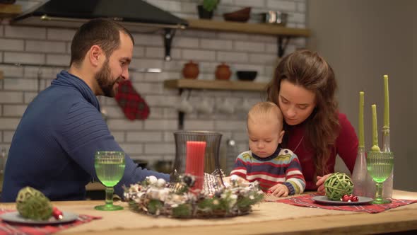 Mother, Father and a Baby Have Fun in Modern Kitchen