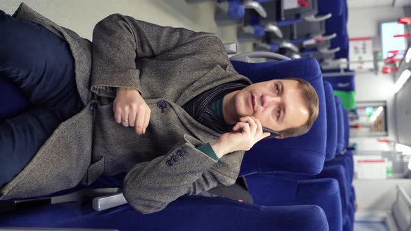 Millennial Man Making Phone Call in Subway Train