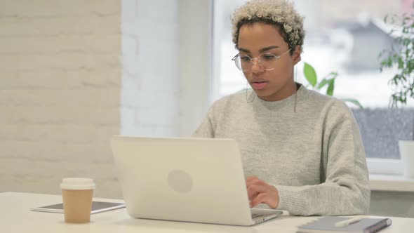 African Woman Having Wrist Pain While Using Laptop in Office