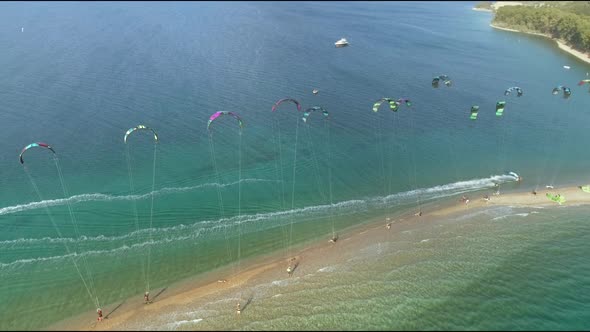 Aerial view of group holding windsurfing parachute at Gulf of Patras, Greece.