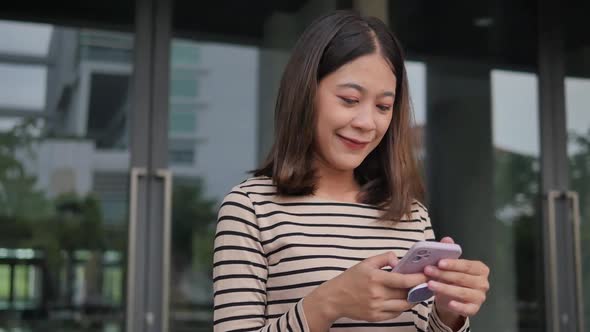 girl checks smartphone News feed back from university wearing streetwear