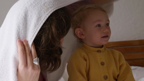 Caucasian family having fun in bedroom at home