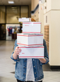 Woman Holding Shipping Boxes in Store - PhotoDune Item for Sale