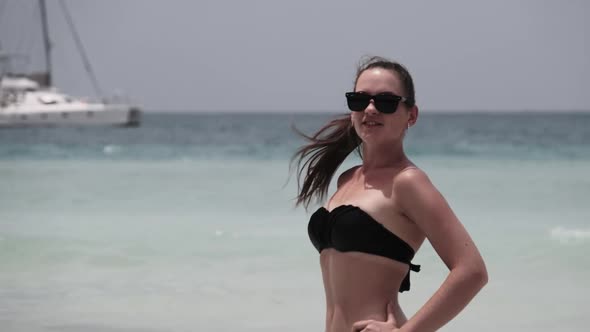 Young Woman in a Bikini Posing on Exotic Beach at the Turquoise Ocean Zanzibar