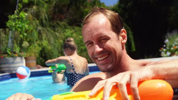 Portrait of man smiling near swimming pool