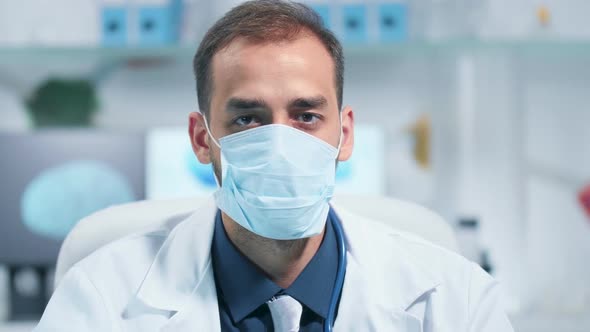 Portrait of a Doctor Wearing a Medicinal Mask and Looking at the Camera