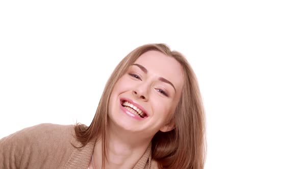Charming Caucasian Female with Light Brown Hair Laughing Smiling at Camera Standing on White