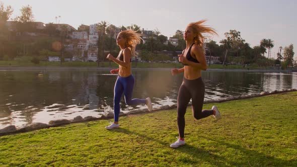 Athletic Twins Running In The Park Slow-Motion