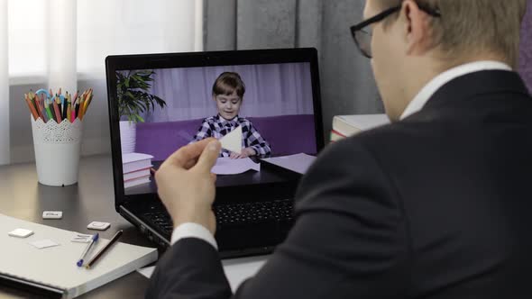 Man Teacher Makes Video Call on Laptop with Children Pupil. Distance Education