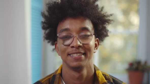 Portrait of African American Man in Eyeglasses Speaking on Video Call at Home