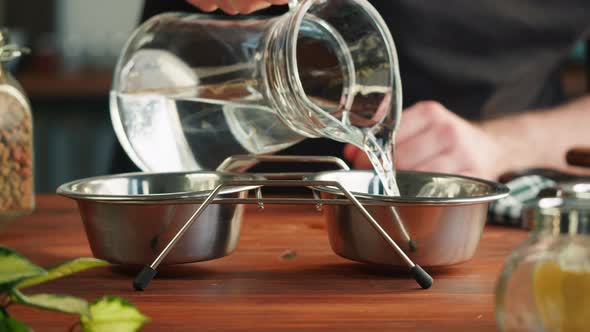 Pouring Water Into Metal Bowl Closeup Dried Dog Food Granules